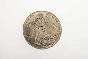 A silver coin depicting a Cuban rebel during the Bay of Pigs and dated April 1961.